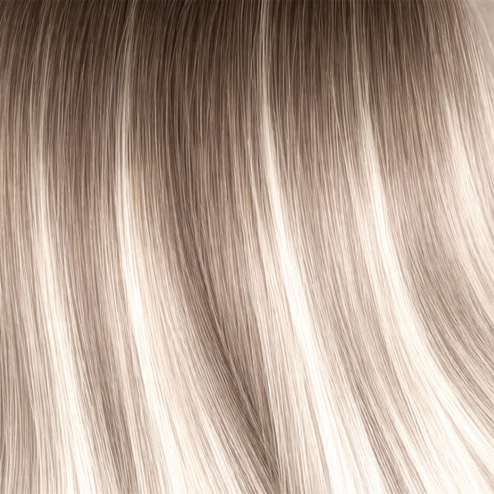 Close-up of Rooted ashy brown into blonde hair strands
