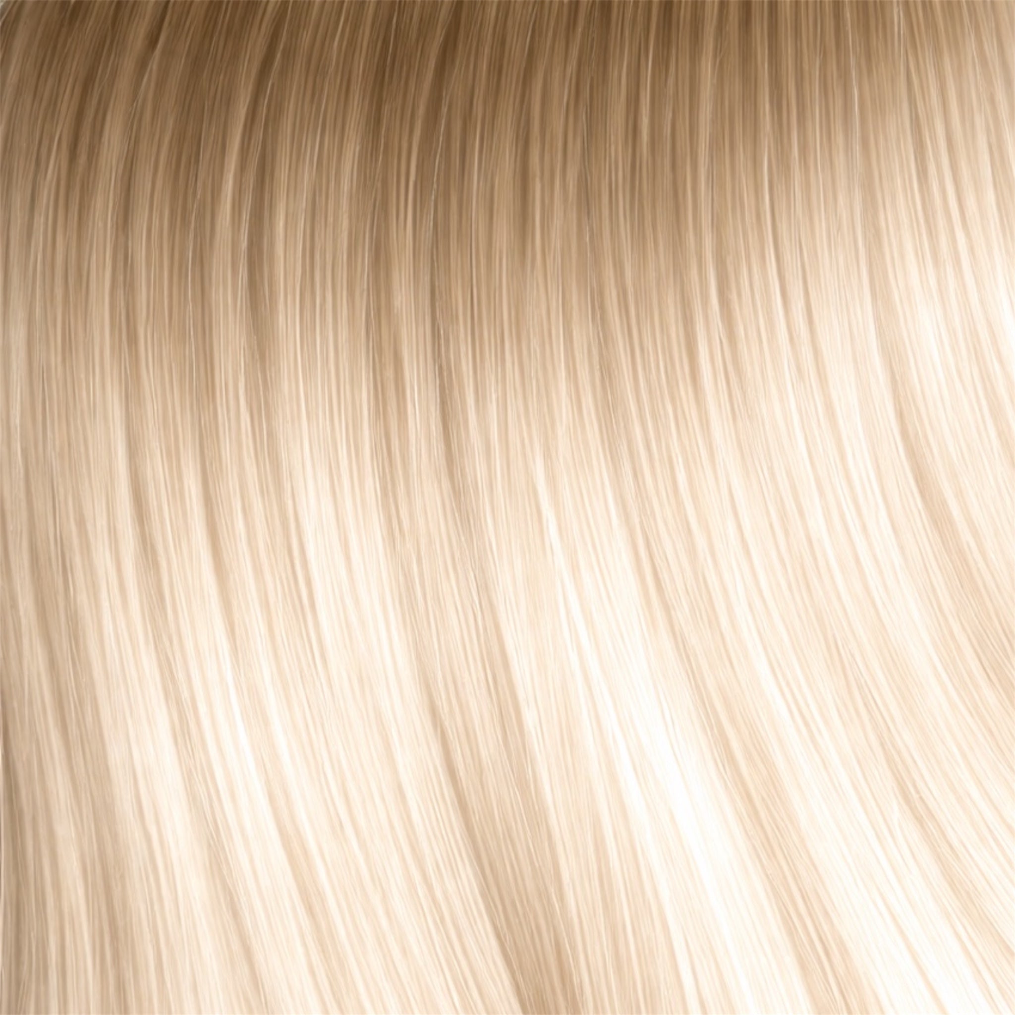 Close-up of deep blonde roots melt into lightest blonde on the ends hair strands